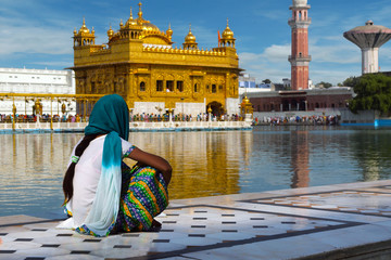 pilgrim at the golden temple in the city of Amritsar-India,main temple of sikh people during sunset...
