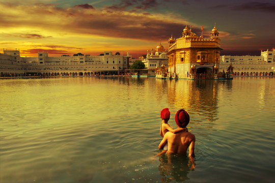 pilgrim at the golden temple in the city of Amritsar-India,main temple of sikh people during sunset time	
