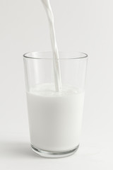 Close up of fresh milk poring into a glass