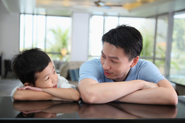 Man and boy waiting at the hotel reception