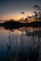 Lake with a perfectly smooth surface at sunset