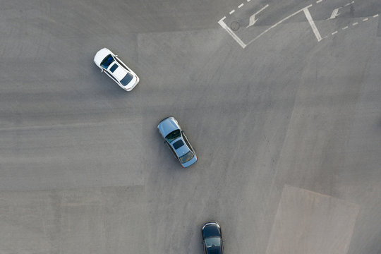Aerial View Of Cars Turning At City Street Intersection