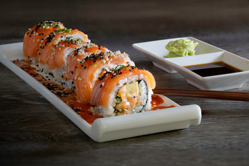 Salmon Sushi japanese food in white dish on gray wooden table dim light