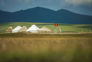 Traditional yurts for tourist with a beautiful landscape at Song Kul Lake where is famous place for tourism in Kyrgyzstan  - 351462791