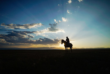 Horse Riding during sunset at Song Kul Lake, Kyrgyzstan - 351463366