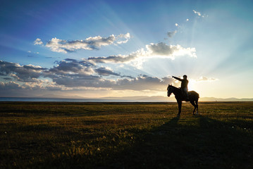 Horse Riding during sunset at Song Kul Lake, Kyrgyzstan - 351463382