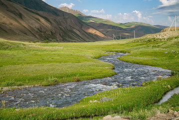 Fototapeta na wymiar Beautiful Mountains with stream view in summer, on the way to Song Kul Lake, Kyrgyzstan 