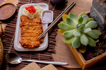 Golden yellow tonkatsu on a white plate