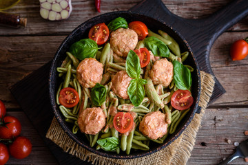 Delicious fresh pasta with meatballs, sauce, cherry tomatoes and basil