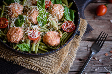 Delicious fresh pasta with meatballs, sauce, cherry tomatoes and basil