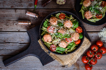 Delicious fresh pasta with meatballs, sauce, cherry tomatoes and basil