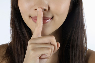 Naklejka premium Woman with finger on lips