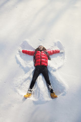 Woman making snow angel