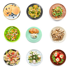 Set of plates with delicious dishes on white background