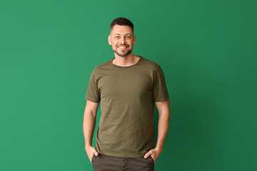 Man in stylish t-shirt on color background