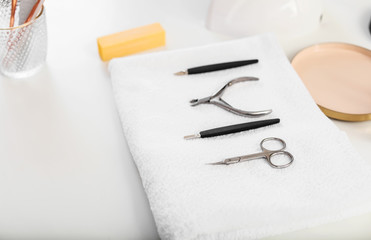 Different tools and towel on table in beauty salon