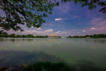 A panoramic nature background of trees, green grass in the park, a large reservoir surrounded, allowing tourists to stop while traveling.