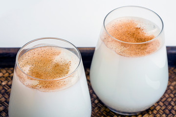 Two glass of homemade traditional mexican or spanish rice Horchata served on a tray. Fresh cool summer drink or cocktail made from rice, vanilla, cinnamon and almond. Copy space for text