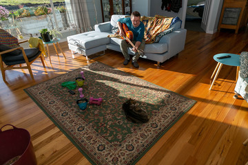 Seniorman in lock down with guitar & cat