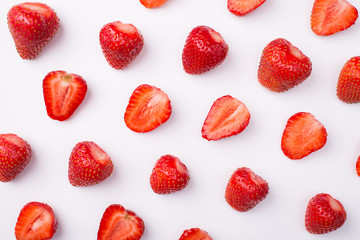 Top above overhead view photo of cut strawberries rows alternate with whole ones isolated on white background