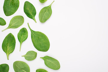 Top above overhead view photo of baby spinach placed on the left side isolated on white background