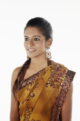 Woman in sari smiling and looking away