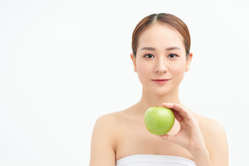 Young woman eating green apple isolated over white background