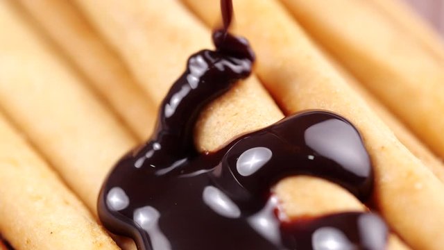 Chocolate pouring on bread stick in 4K Resolution. Topping chocolate on homemade bread stick dessert