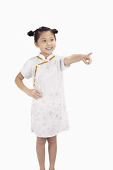 Girl in cheongsam smiling and pointing with finger