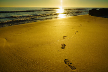 Sunset and footprints on beach