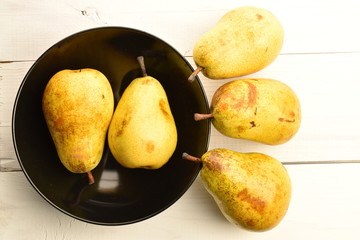 Juicy sweet, organic pears, close-up, on a painted wooden table.