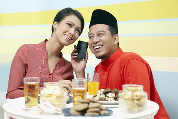 Man and woman listening to phone conversation together
