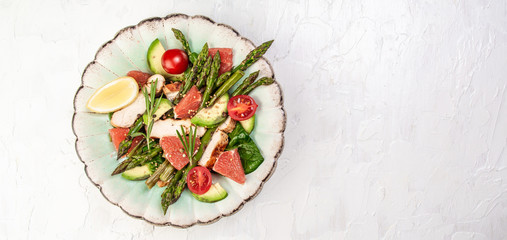 Ketogenic diet. Dinner dish with chicken meat asparagus, avocado, tomatoes. Detox and healthy concept. Keto food. Overhead, top view, flat lay