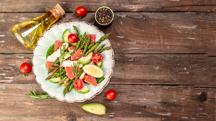 Asparagus salad grapefruit, cherry tomatoes, avocado, chicken fillet, spinach in bowl. top view. Long banner format. space for text.
