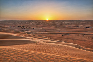 Fototapeta na wymiar A beautiful sunset in a calm and lonely desert horizon.