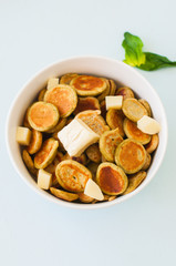 Spinach pancake cereals in a white bowl.