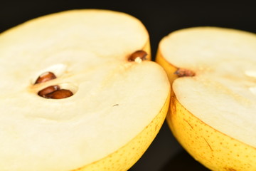 Juicy sweet, organic pears, close-up, on a black background.