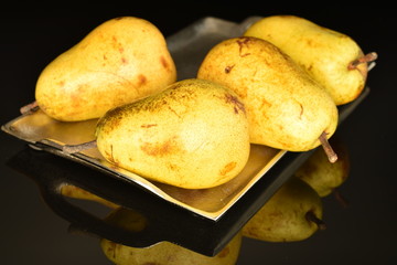Juicy sweet, organic pears, close-up, on a black background.