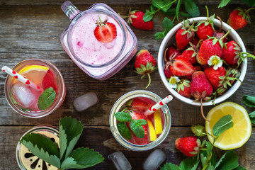 Healthy dieting concept. Lemonade with fresh strawberries and Strawberry fruit Yogurt smoothie or milk shake on a rustic wooden table. Top view flat lay background.