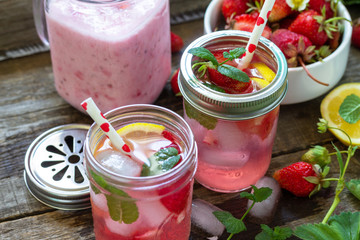 Healthy dieting concept. Lemonade with fresh strawberries and Strawberry fruit Yogurt smoothie or milk shake on a rustic wooden table.