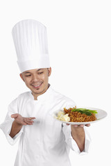 Asian chef with a plate of wonton noodles