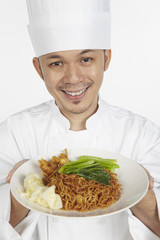 Asian chef with a plate of wonton noodles