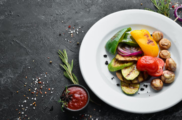 Grilled vegetables: zucchini, tomatoes, paprika, onion. Top view. Free space for your text.