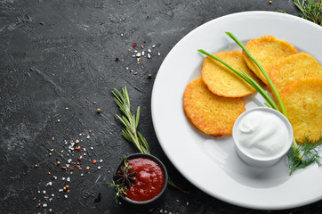 Potato pancakes with sour cream and onions. Top view. Free space for your text.