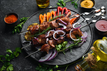 Grilled veal skewers and grilled vegetables. Top view. Barbecue.
