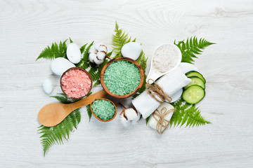 Aromatic colored sea salt on a white wooden table. The concept of cosmetics and spa. Top view. Free copy space.
