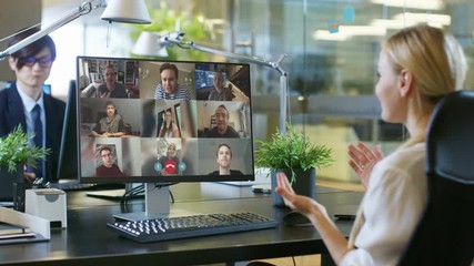 In the Office: Businesswoman Uses PC Conference Video Call Software App to Talk with a Group of Remote Working Colleagues. Businesspeople doing Online Meeting, Working from Office, Home Office - Powered by Adobe