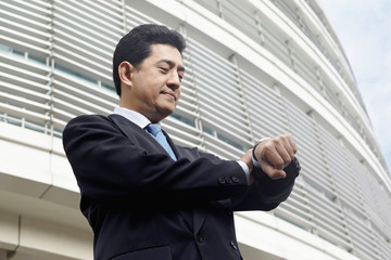 Fototapeta premium Businessman checking the time on wristwatch