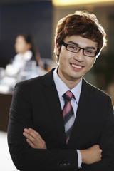Fototapeta premium Businessman smiling with arms crossed