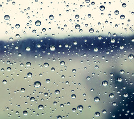 black and white rain water drops on a window glass close up , gray drop macro in a golden light ; backdrop textute background